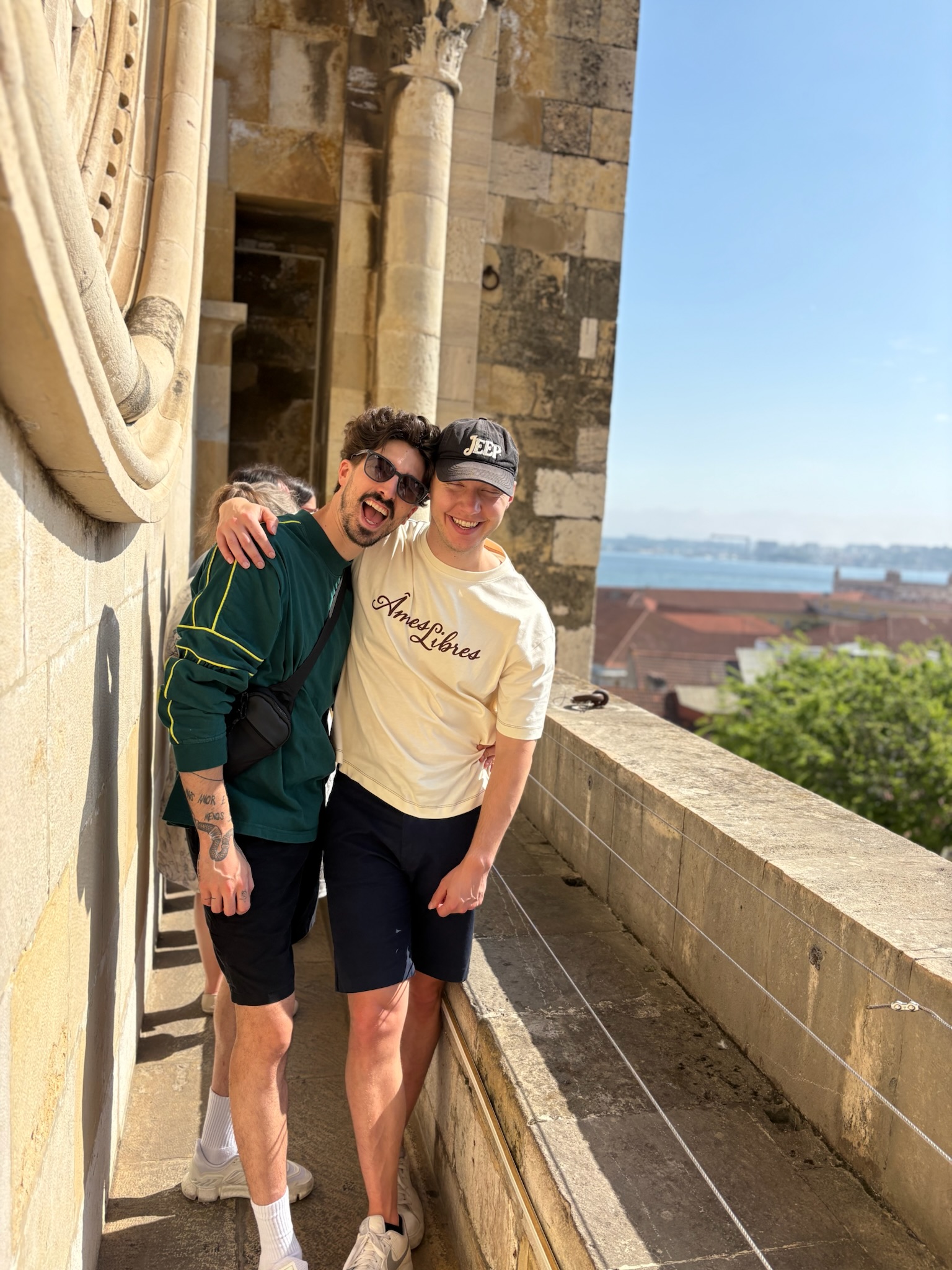 Ryan and Joao smiling together on a sunny trip